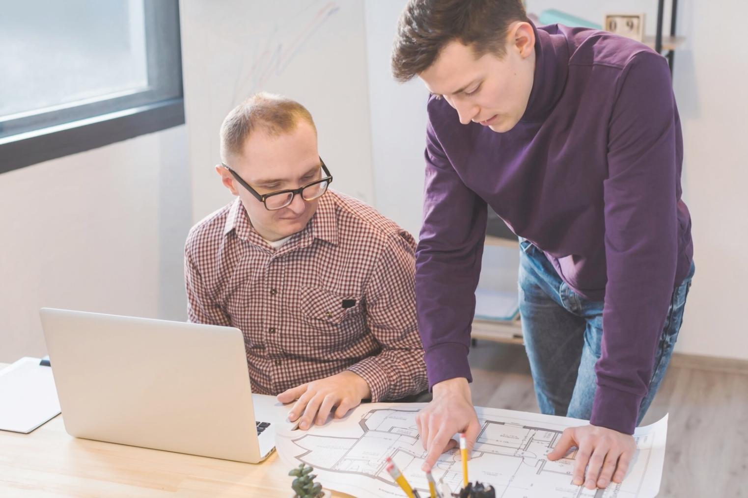 Finance professionals collaborating on budget analysis in modern workspace